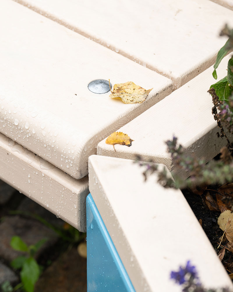 Close up of rosenlund seating bench with rain droplets on the material.